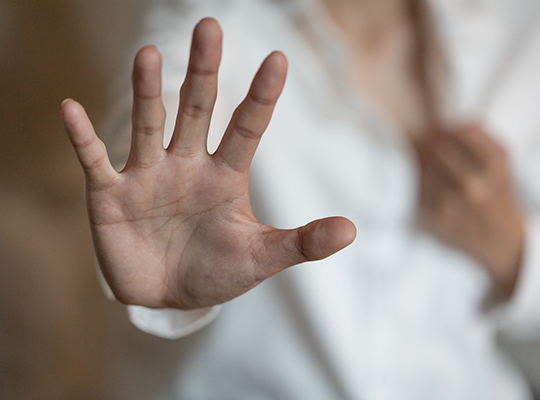 Woman holding up hand indicating stop