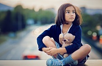 A young kid holidng a teddy bear photo