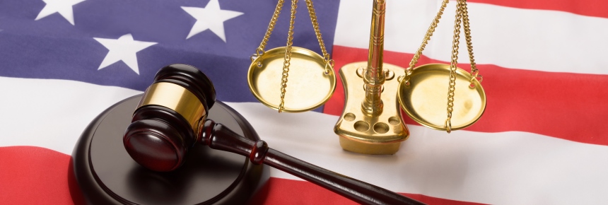Justice scale, gavel, and US flag