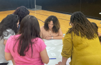 few females discussing around a table 