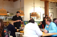 Guests talking to the chef at the table