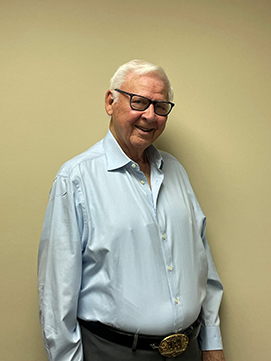 Photograph of Jimmy Klein in front of a blank wall.