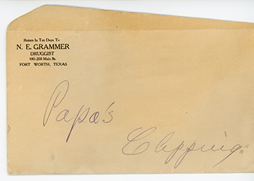 Yellowed, worn envelope with printed black text at top left reads Return In Ten Days to N. E. Grammer Druggist, along with the Fort Worth address. Blue ink handwritten inscription across middle and lower part of envelope reads Papa's Clippings.