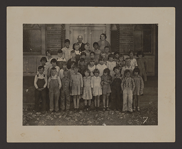 Group class photograph outside of the Haslet Public School building, circa 1920