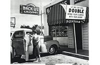 Katherine Backus Durbin Placing Clean Clothes in Car in Front of Backus Laundry & Cleaning, reproduction of photograph, by Don Loyd Photo, undated