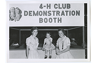 Two young women, One young girl, 4-H Club Demonstration Booth (021-003-697)
