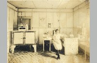 Shaw Bros. Creamery Laboratory with unidentified woman (019-012-677)