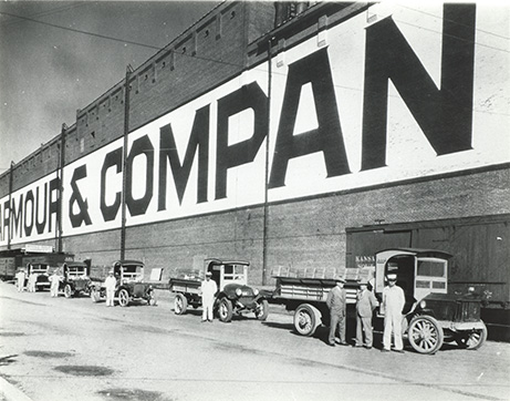 Armour delivery trucks in front of packing house