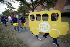 Children walking to their school on Walk to School Day at C.C. Moss Elementary