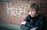 Girl next to Help sign