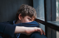 Teenage boy looking distressed