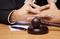 hands crossed before a gavel