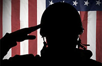 soldier solute in front of the flag
