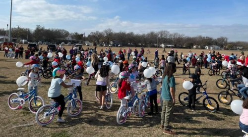 SANTA AND STUDENTS WITH NEW BIKES