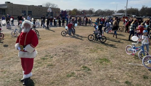SANTA AND STUDENTS WITH NEW BIKES