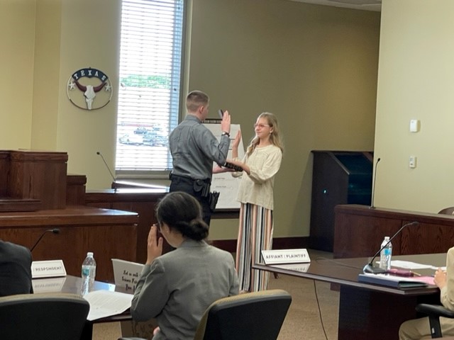 DEFENDANT GETTING SWORN IN BY A BAILIFF