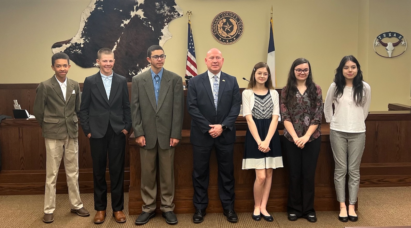 PHOTO OF A JUDGE WITH SIX STUDENTS