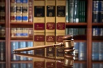 gavel on desk in front of law books