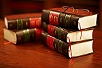 two stacks of law books with glasses on top
