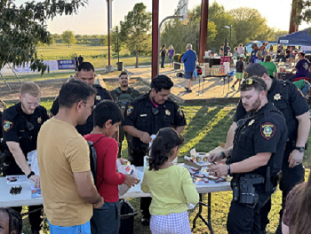 Officers handing out stickers to children