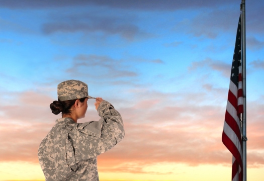 A woman in military uniform salute the flag
