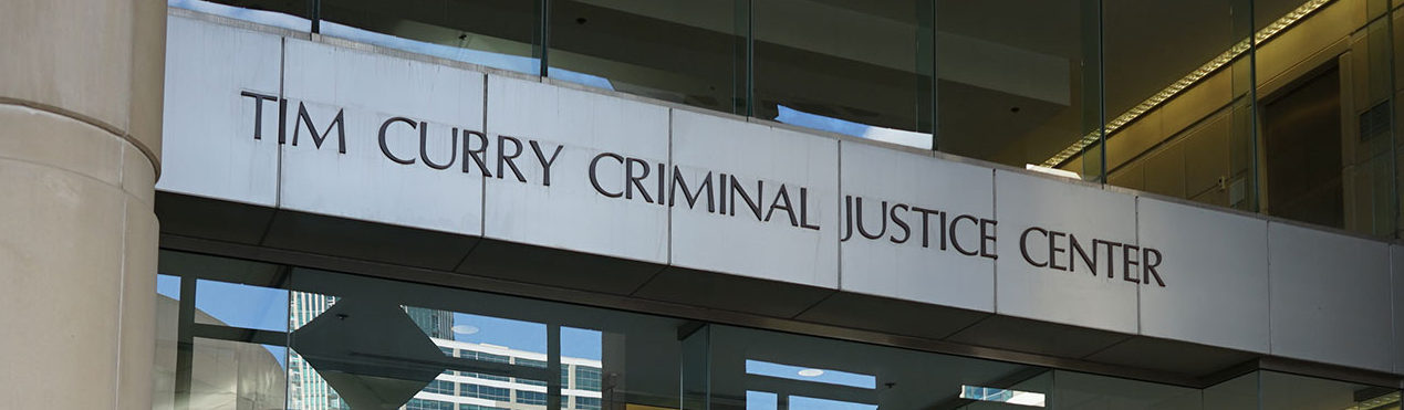 Sign on building reading Tim Curry Criminal Justice Center