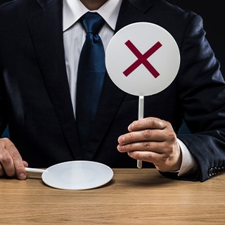 a man holding X sign