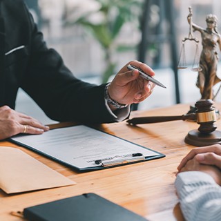 a man pointing pen on gavel