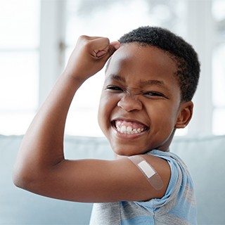 Child with band aid on arm