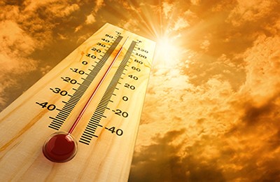 bright sun radiating heat, thermometer showing high temp