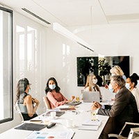 Office staff wearing masks during meeting