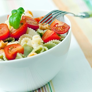 Cherry tomatoes and pasta in a bowl