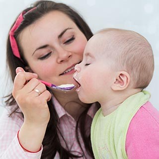 Infant being fed by her mom