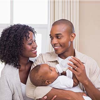 Parents feeding infant