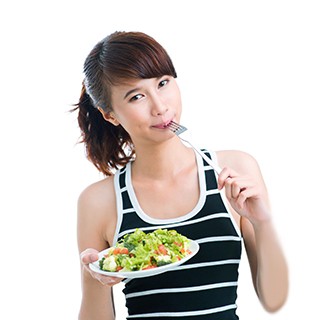 Teenager eating a salad 