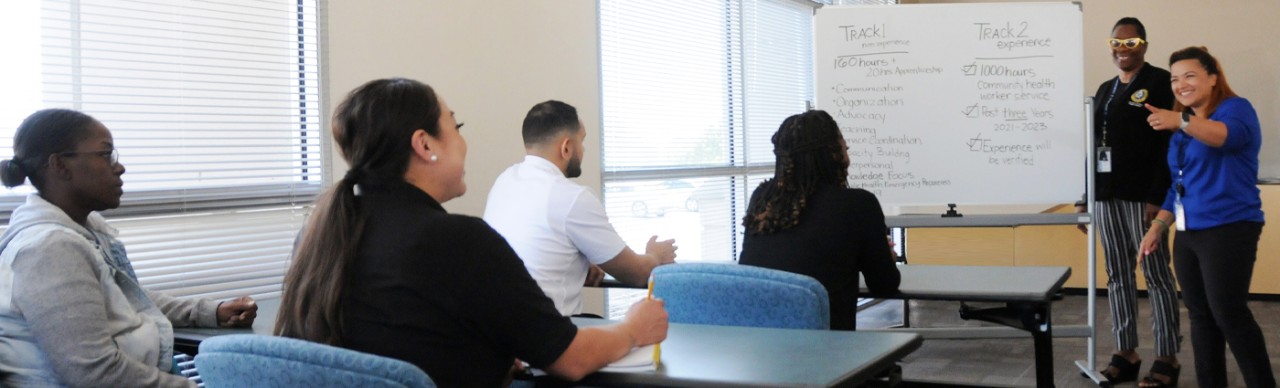 Community members sitting at tables