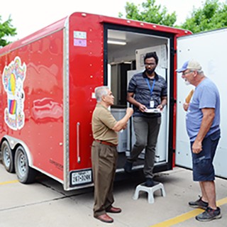 Food inspectors talking with mobile food vendor